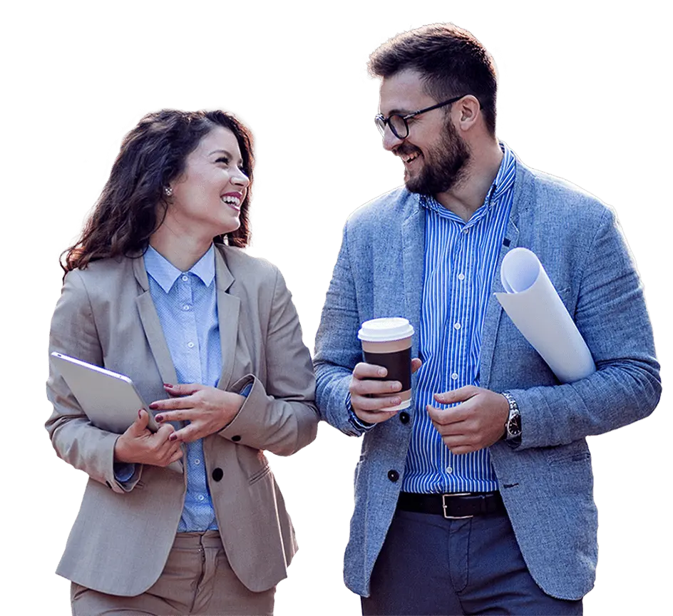 Employees with coffee mugs smile at each other while on their way