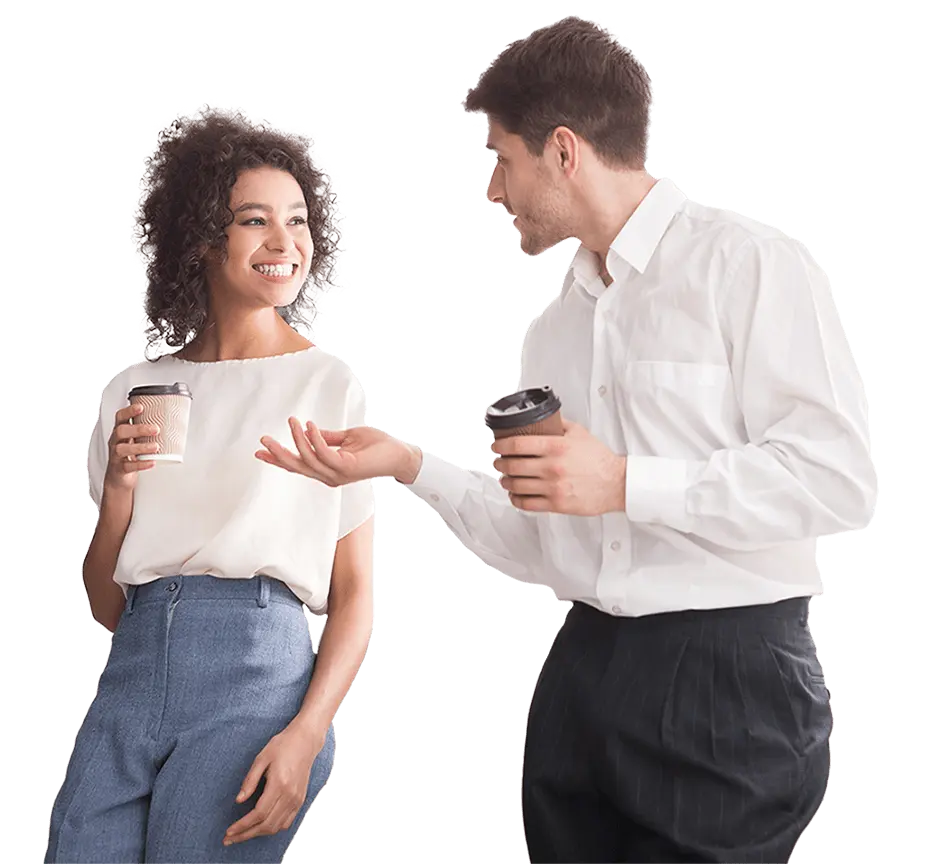 Male employee with coffee mug in conversation with a female employee
