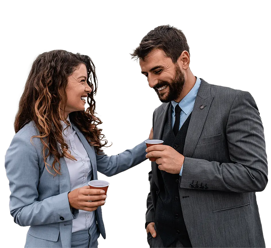 Female employee taps a male employee on his shoulder, smiling